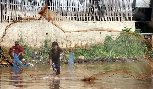 Fisherman casting his net in Myanmar