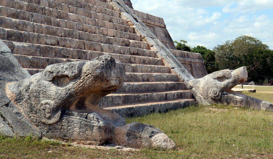 Snake carvings at the base of the northern staircase of El Castillo in Chichen Itza