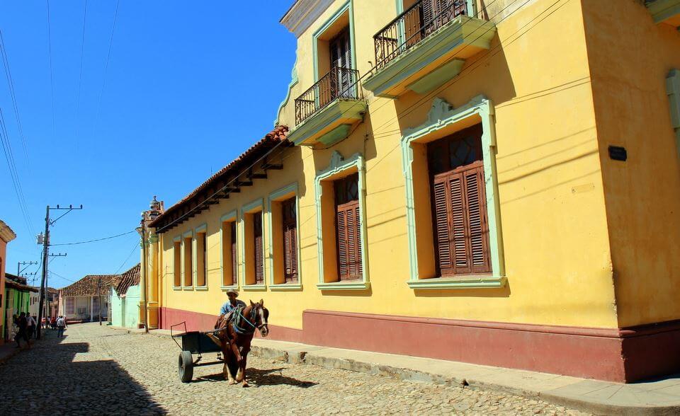 A horse and cart traverses the cobbled streets of Trinidad in Cuba