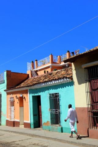 A man walking along the coloured street of Trinidad